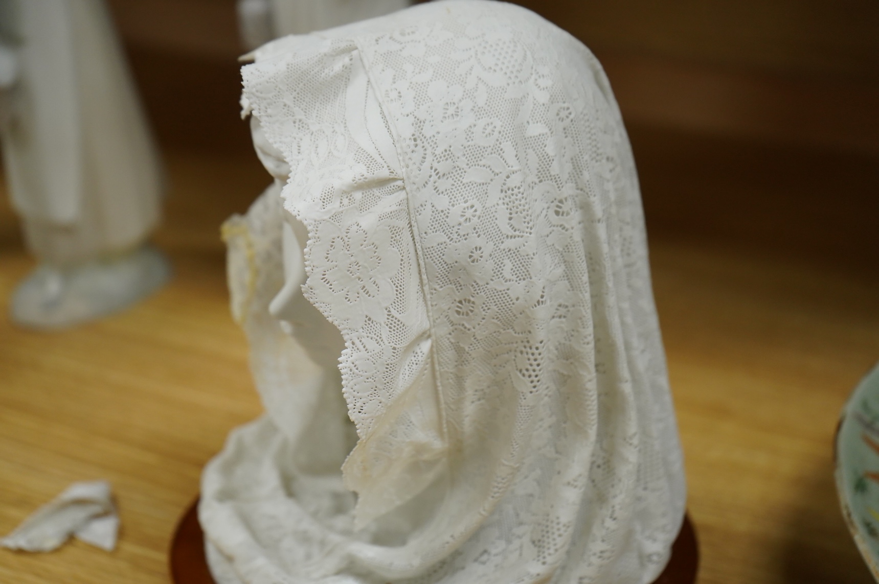 A group of Lladro figures: Bust of a lady in a lace veil, Girl with a basket, Lady holding gloves and a male reaper, 43cm high - 4 items, some boxed.